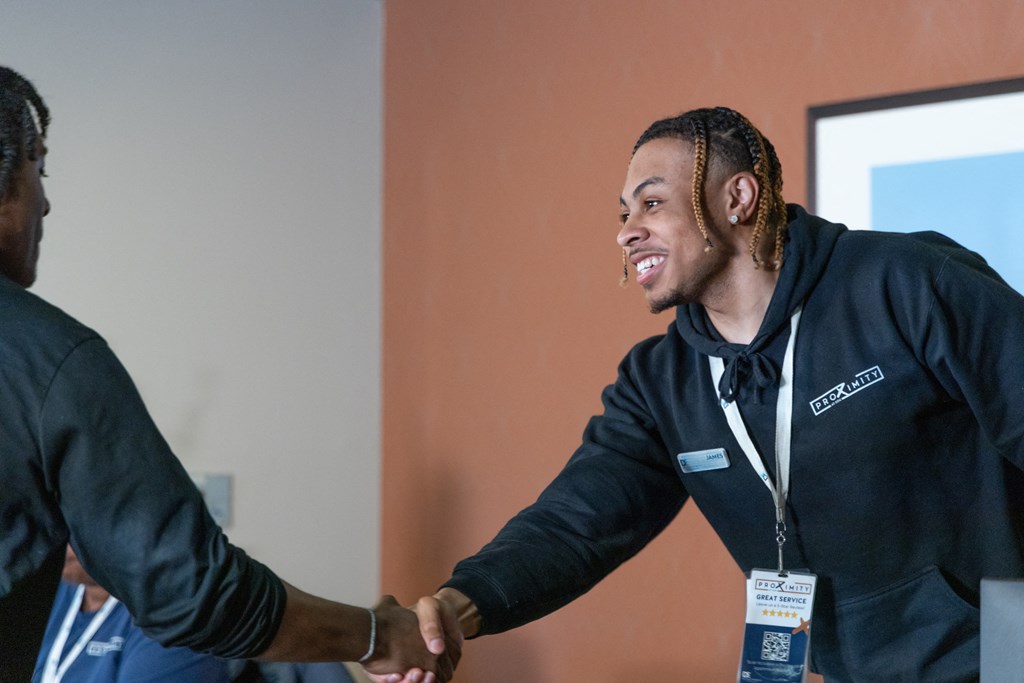 a man shaking another mans hand at a networking event
