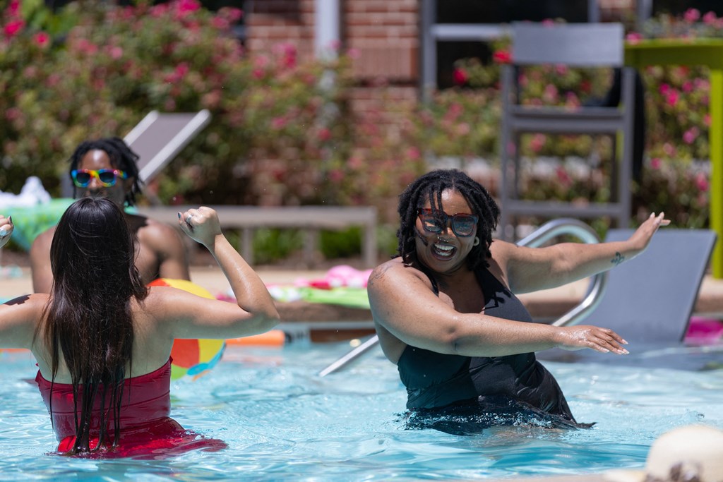 a group of women in a pool playing in the water