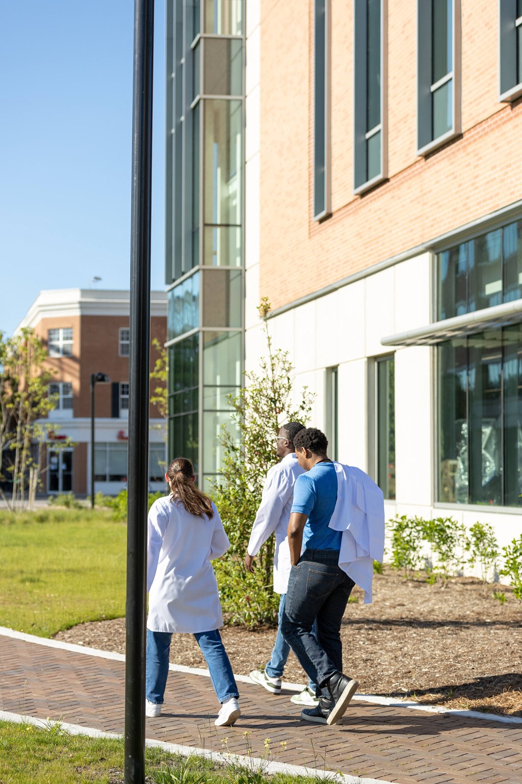 a group of people walking outside of a building