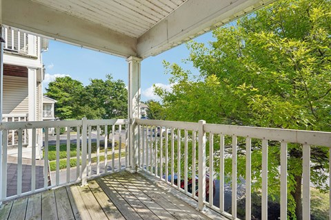 A white railing on a wooden deck.