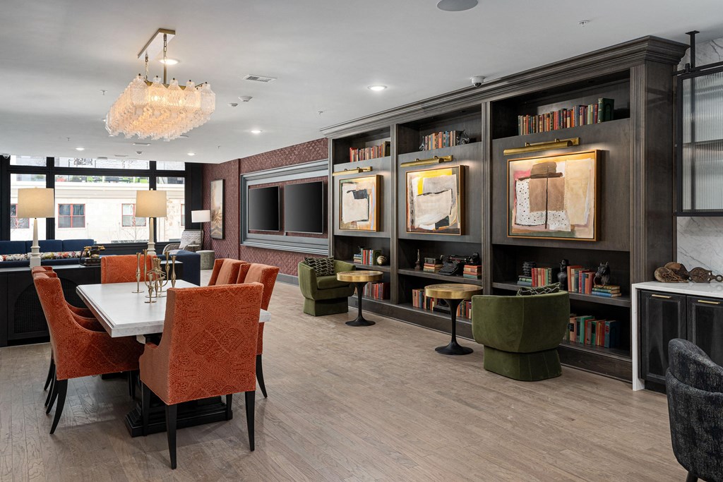 a dining room with a table and chairs and a television at The Madison, Columbus, 43215