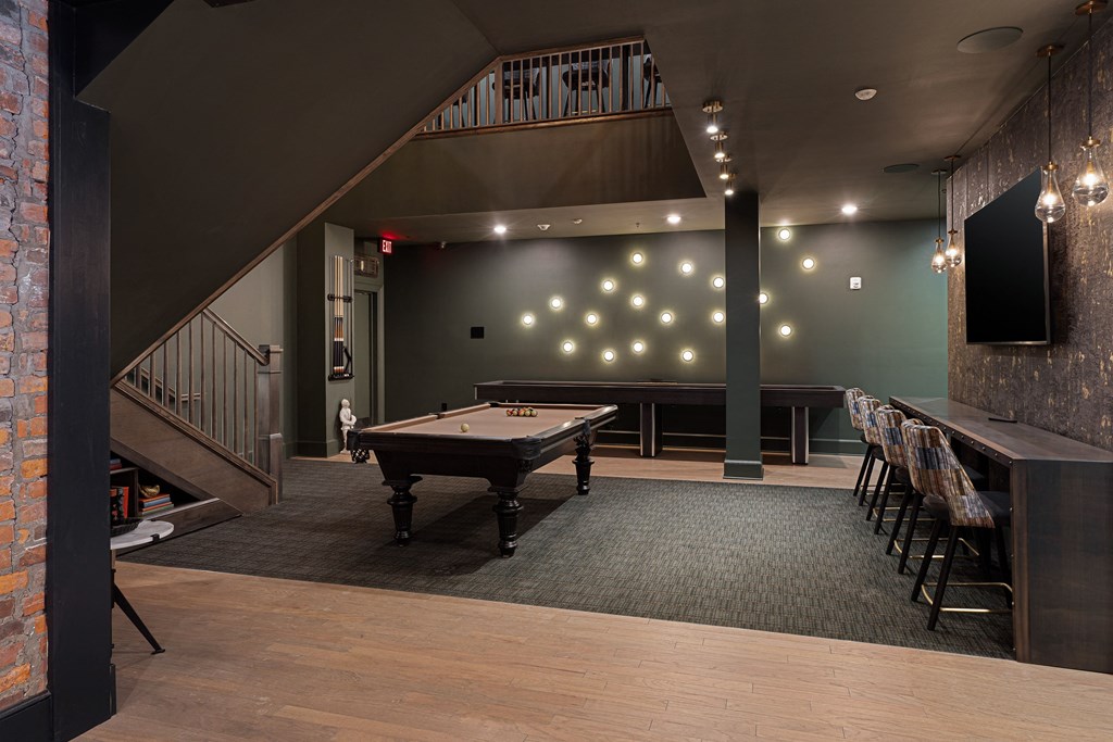 a game room with a pool table and a bar at The Madison, Columbus, Ohio