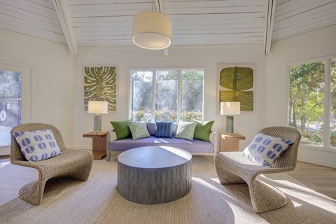 a living room with a couch and chairs and a table