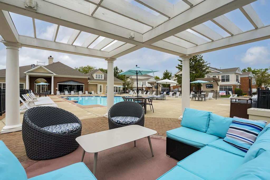 A white pergola over a patio with a pool in the background. at The Orchard, Dublin, Ohio