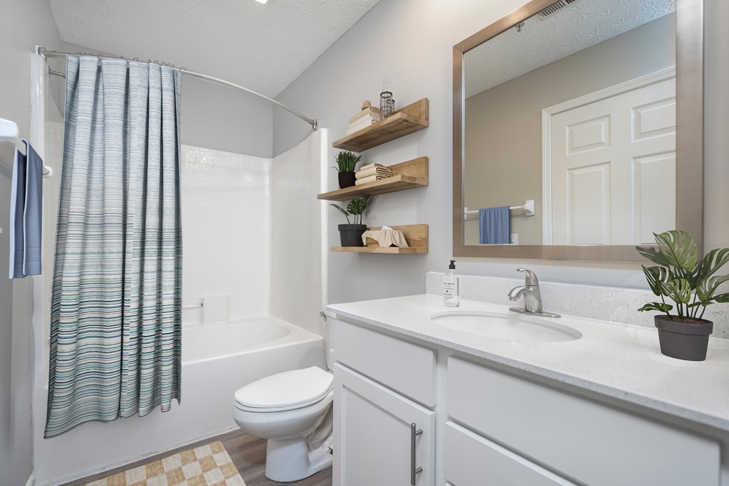 A white bathroom with a toilet, sink, and shower. at The Orchard, Dublin