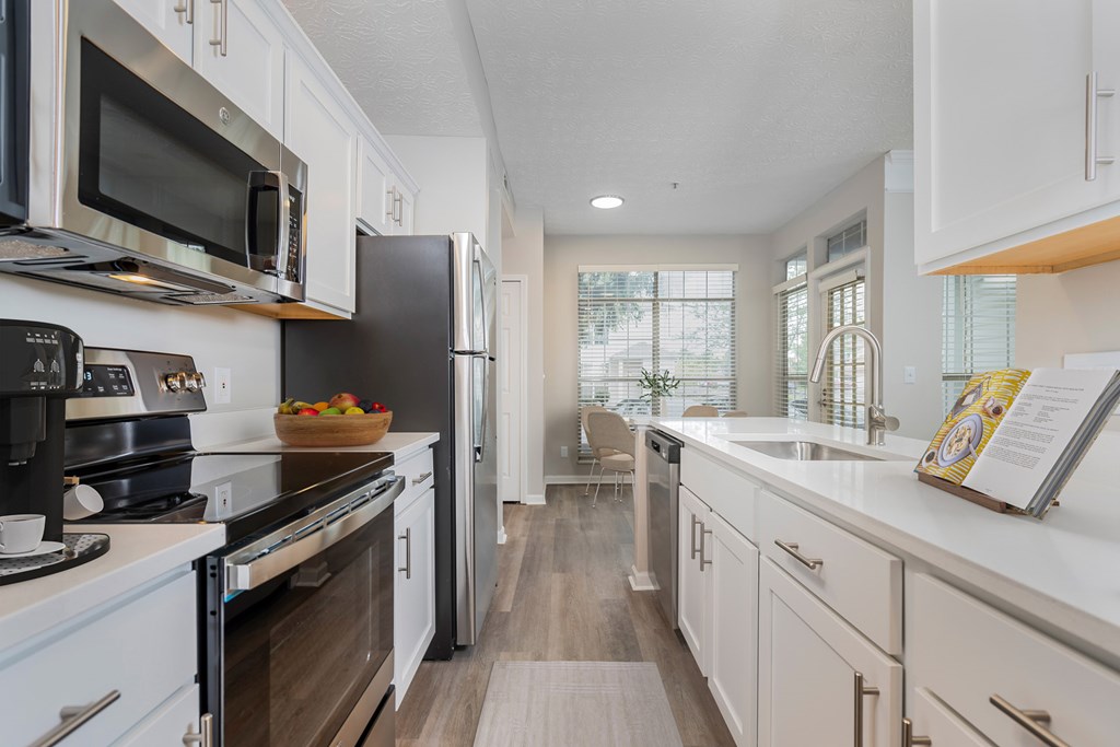 A modern kitchen with white cabinets and a wooden floor. at The Orchard, Dublin, 43016