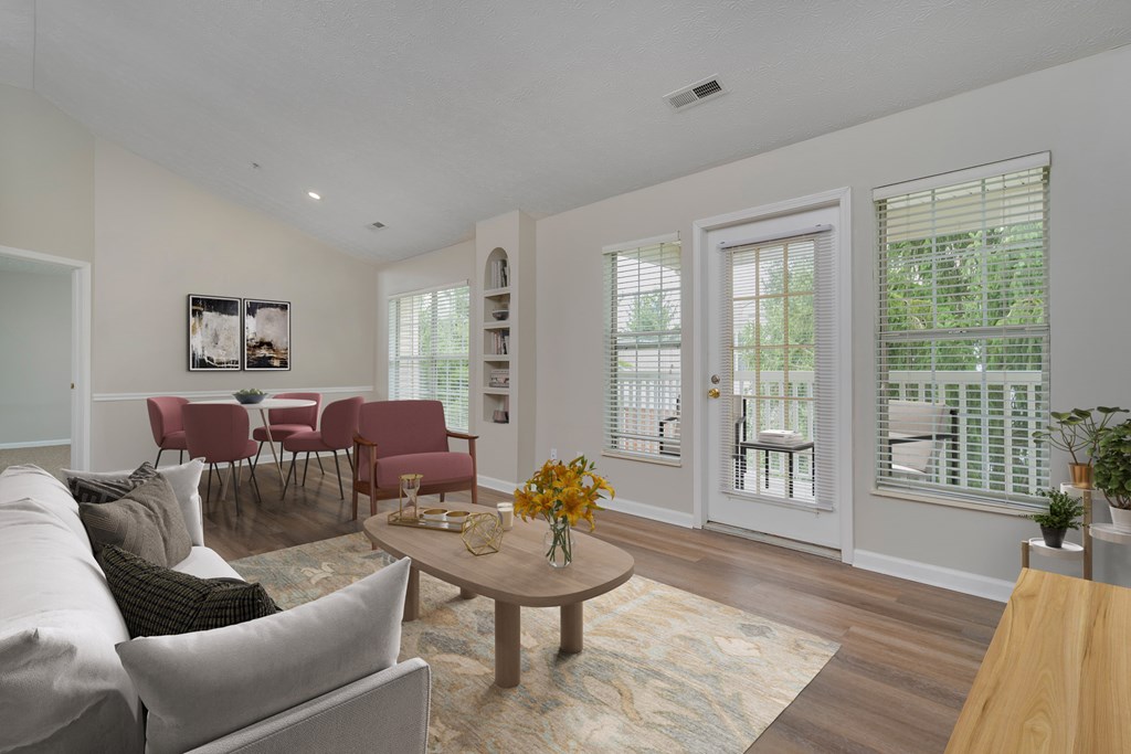 A living room with a grey couch, a coffee table, and a dining table with chairs. at The Orchard, Dublin, 43016