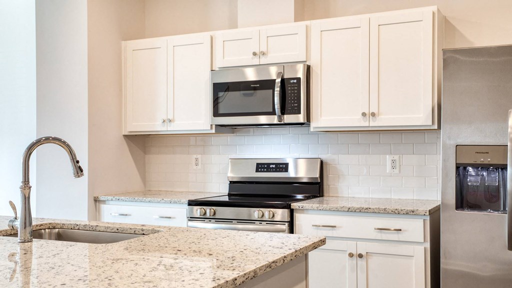 Kitchen White cabinetry and tile backsplash at The Mark Townhomes Apartments, Virginia, 22801