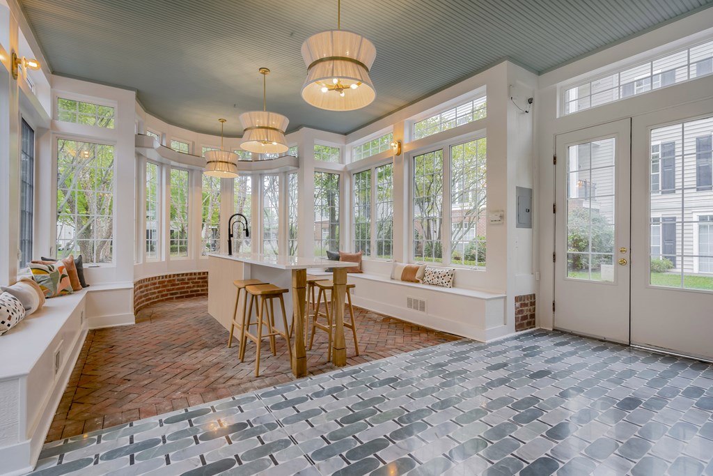 A sunroom with a brick floor and a white ceiling. at Times Square, Dublin, OH