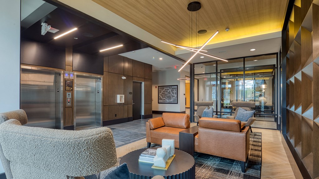 a lobby with couches and chairs and a tableat Aura Stonebridge, Richmond Virginia