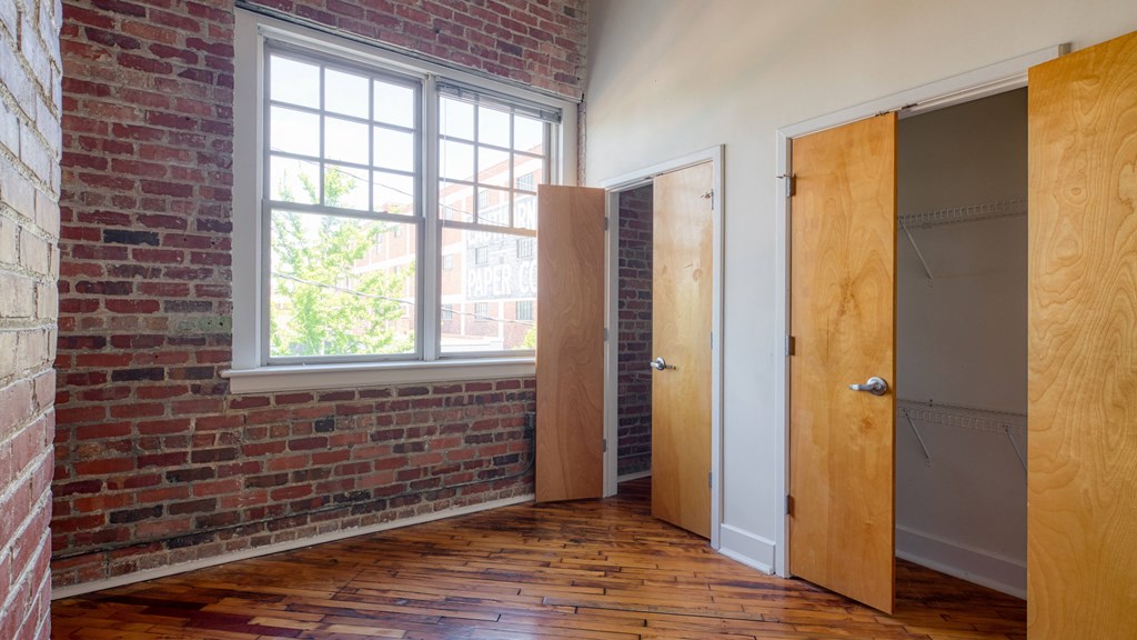 an empty room with two doors and a window