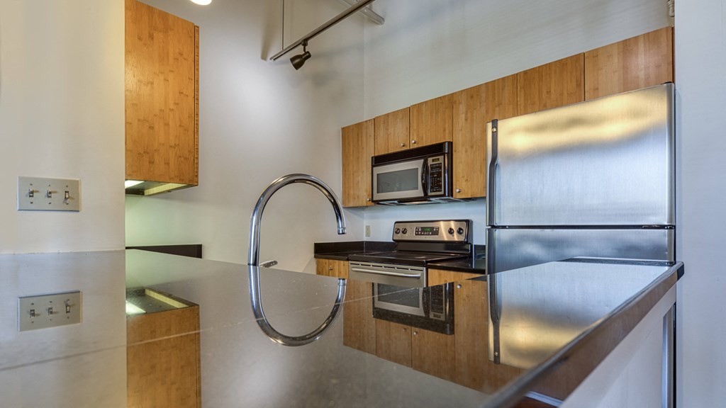 a kitchen with stainless steel appliances and a stainless steel sink