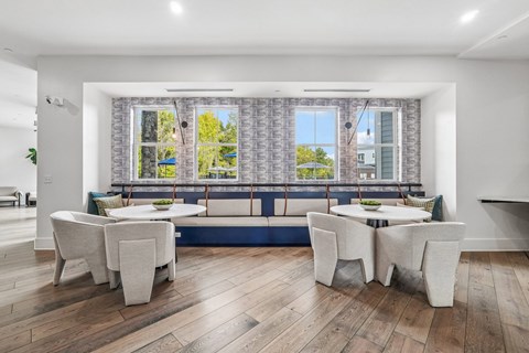 A dining room with a table set for four.