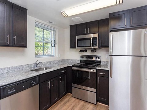 a kitchen with stainless steel appliances and granite counter tops