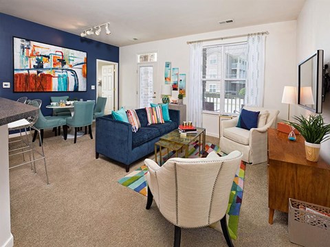a living room with blue walls and white furniture