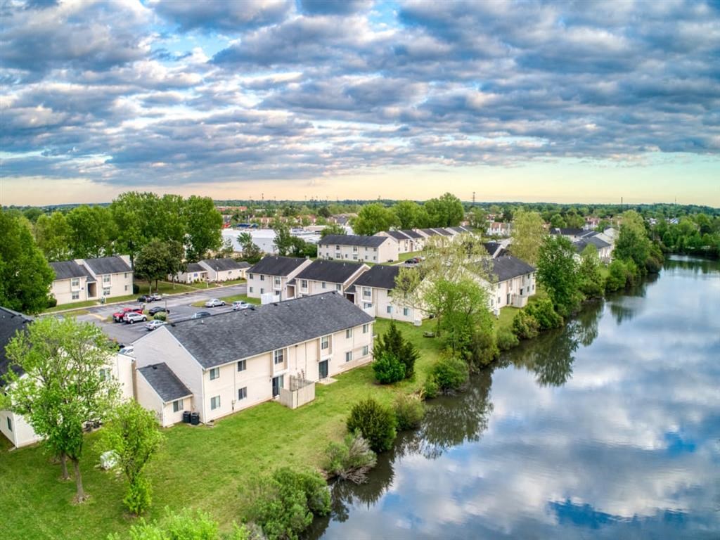 an aerial view of a row of houses next to a river