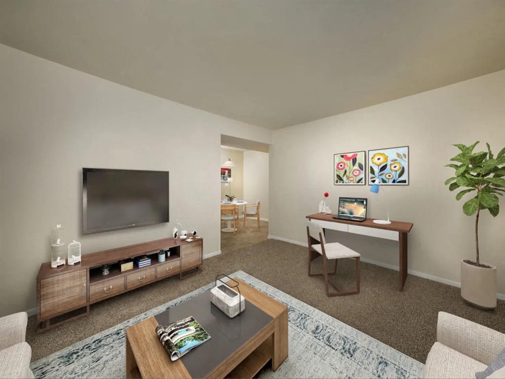 a living room filled with furniture and a flat screen tv