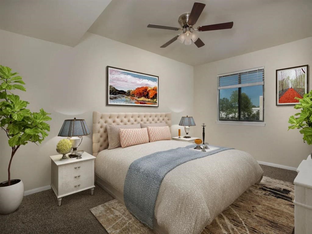 a bedroom with a bed and a ceiling fan