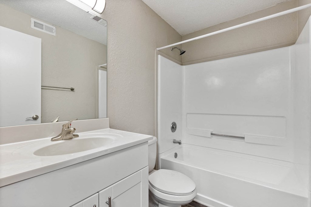 a white bathroom with a sink and a toiletat Village 1373, Greensboro, 27455