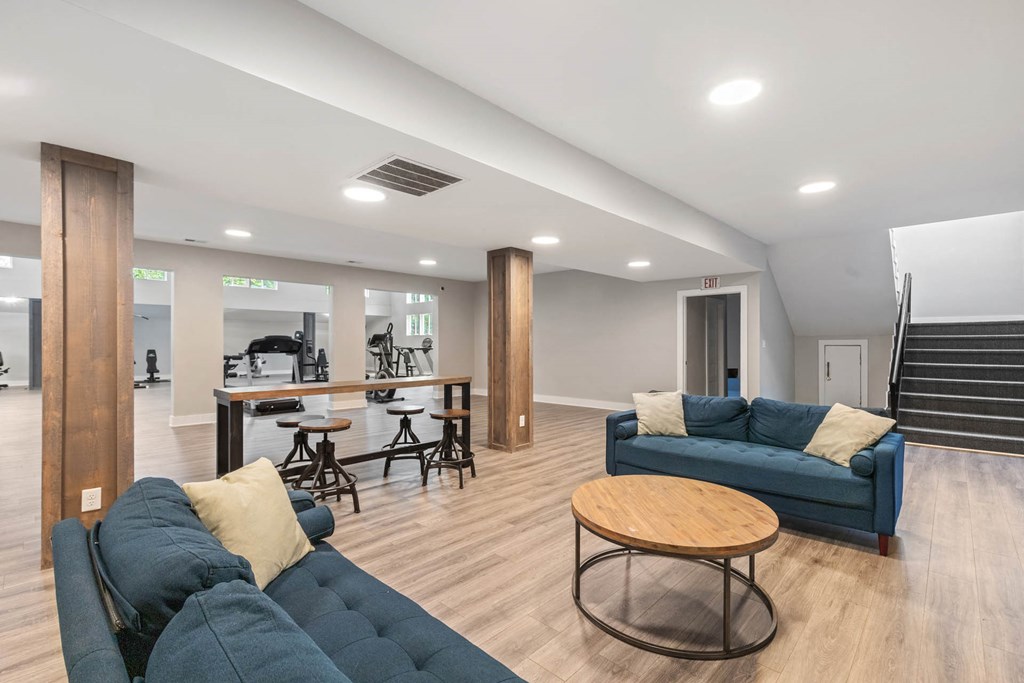 a living room with couches and a bar and a staircase   at Village 1373, Greensboro, NC 27455