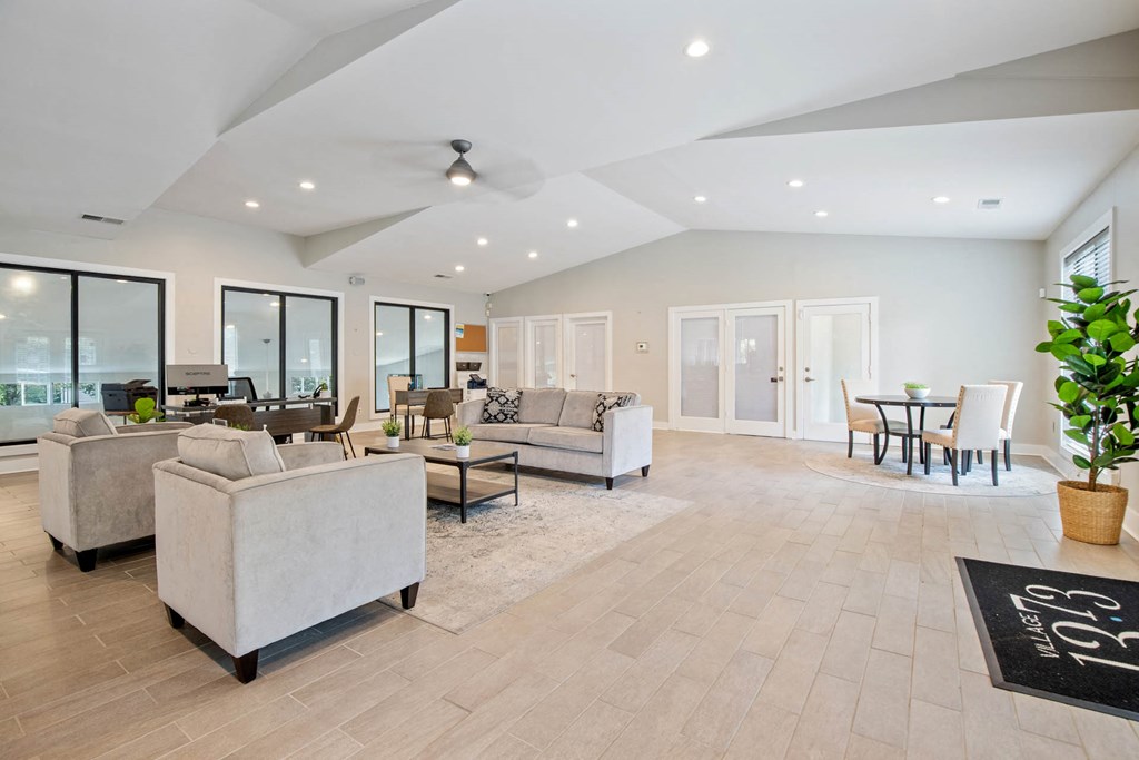 a living room with couches and chairs and a tableat Village 1373, Greensboro North Carolina