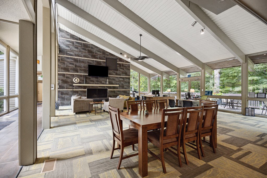 a covered patio with a fireplace and a dining table