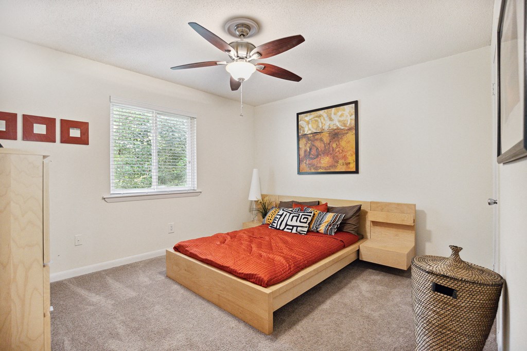 a bedroom with a bed and a ceiling fan