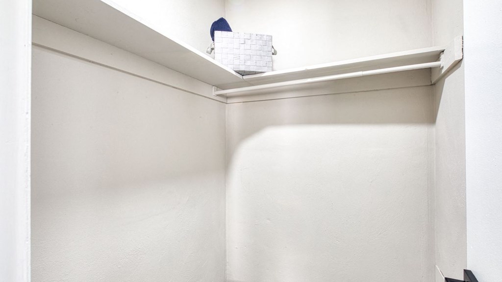 a small closet with a white wall and a shelf at Bayville Apartments, Virginia Beach, Virginia