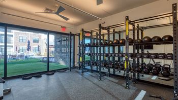 A gym with a view of a cityscape outside the window.