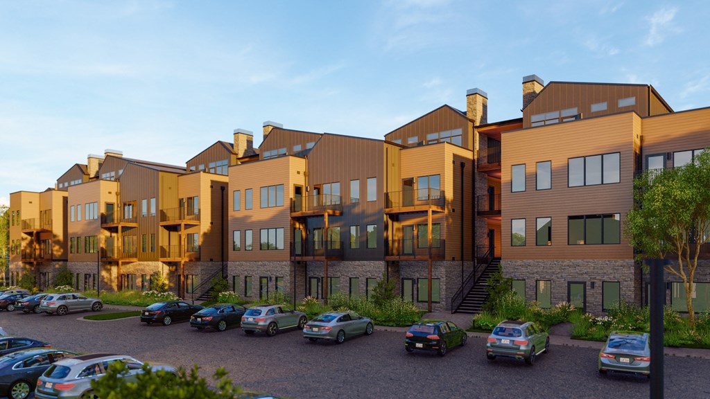 a row of apartment buildings with cars parked in front of them at Terraces at High Mountain, Alabama