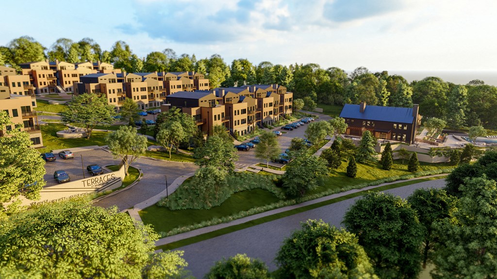 an aerial view of an apartment complex with trees and a parking lot at Terraces at High Mountain, Alabama, 35811