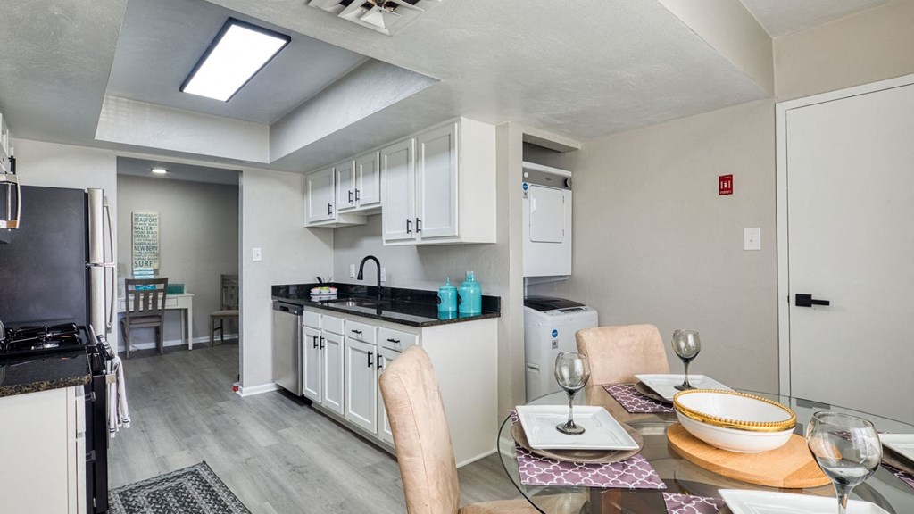 a kitchen and dining room with a table and chairs  at Bayville Apartments, Virginia Beach, 23455