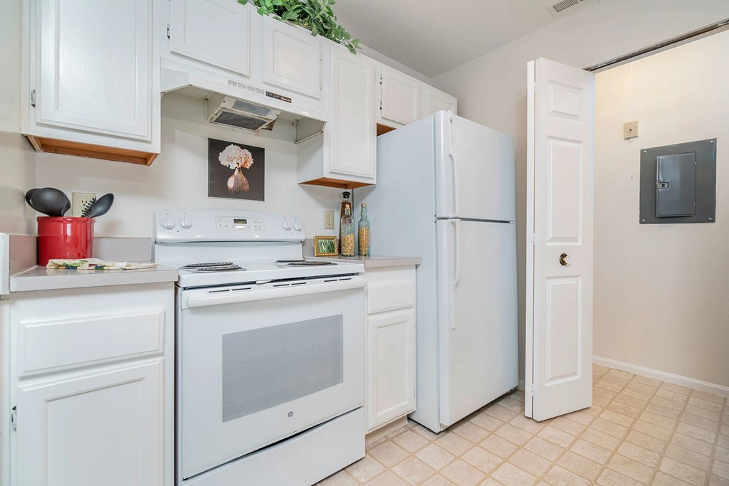 A white kitchen with a fridge, oven, and microwave.at Camden Place, Ohio 43016