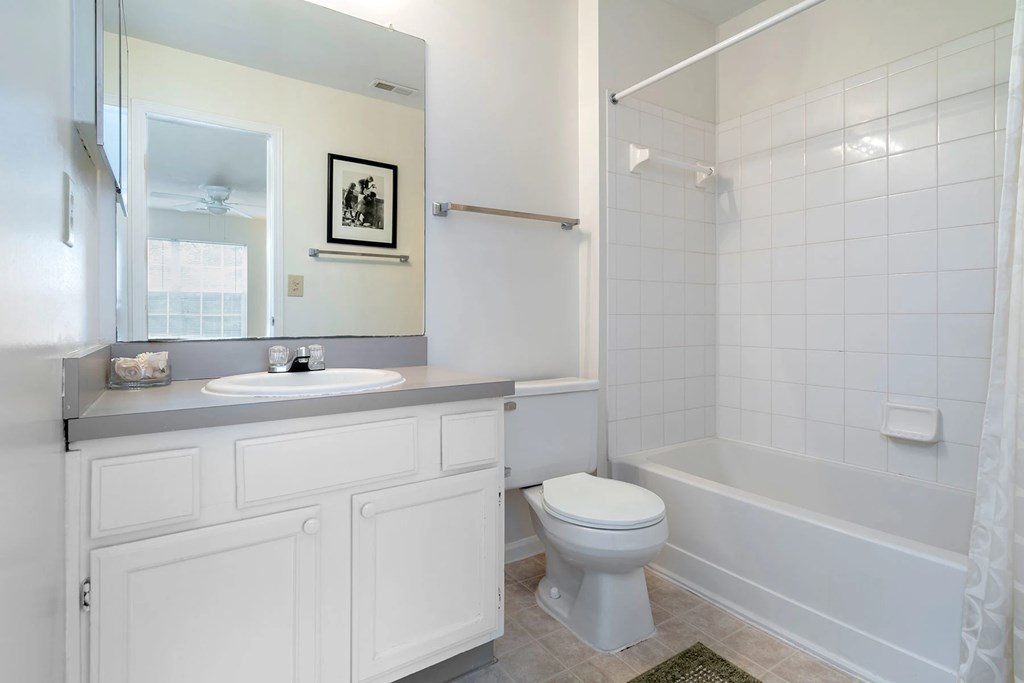 A white bathroom with a toilet, sink, and bathtub.at Camden Place, Dublin, OH