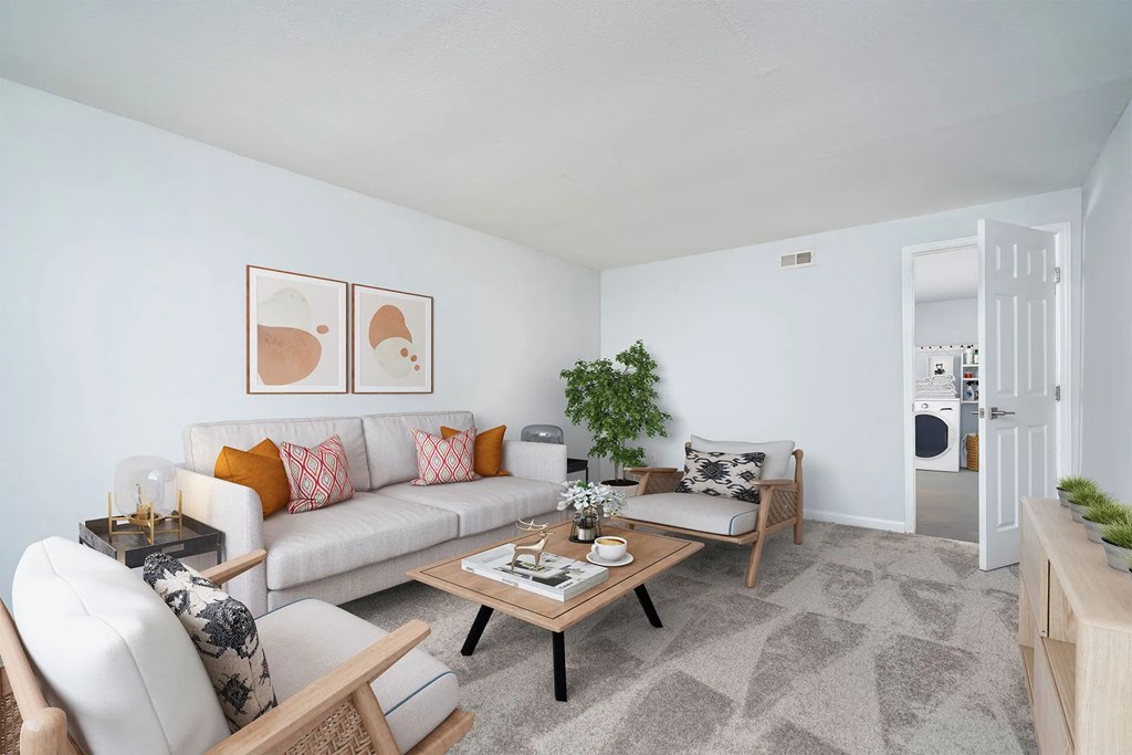 A living room with a white couch and a coffee table.at Camden Place, Dublin, OH