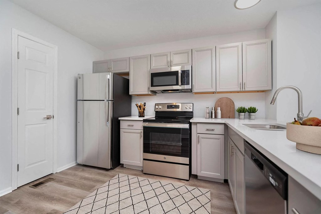 A kitchen with white cabinets and stainless steel appliances.at Camden Place, Ohio