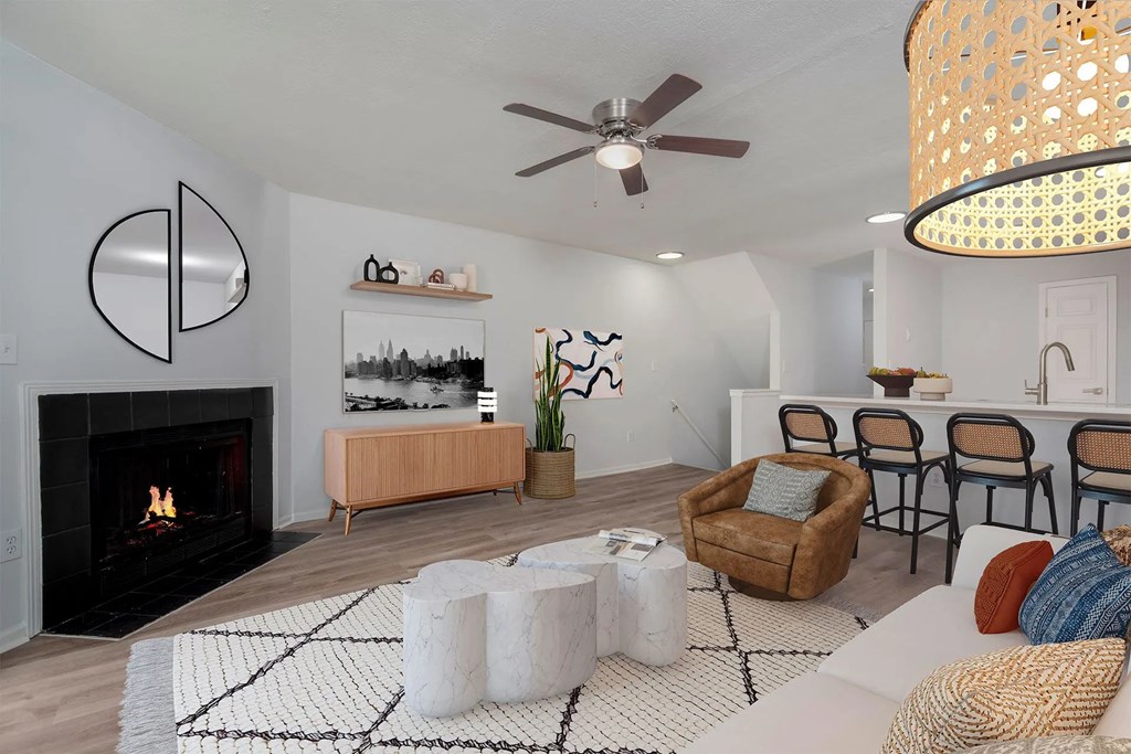 A living room with a fireplace and a ceiling fan.at Camden Place, Ohio 43016