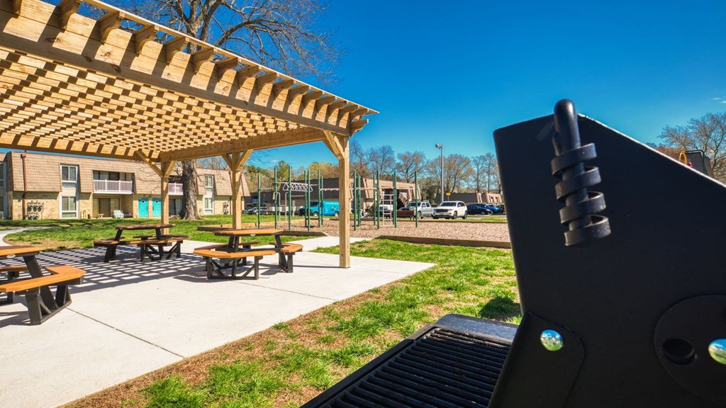 a grill in front of a park with picnic tables  at Bayville Apartments, Virginia Beach, 23455
