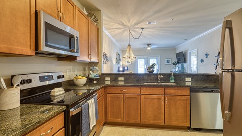 A kitchen with wooden cabinets and granite countertops.