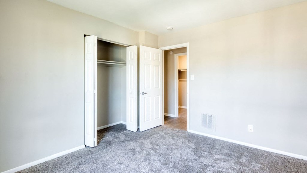an empty bedroom with a closet and a door open at Bayville Apartments, Virginia Beach, Virginia