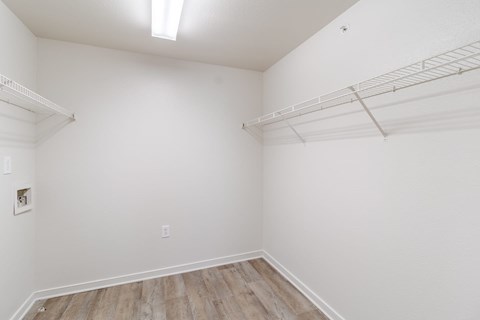 Empty room with white walls and wooden floor.