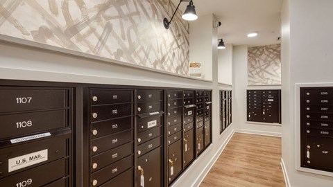 A row of mailboxes are lined up on a wall.