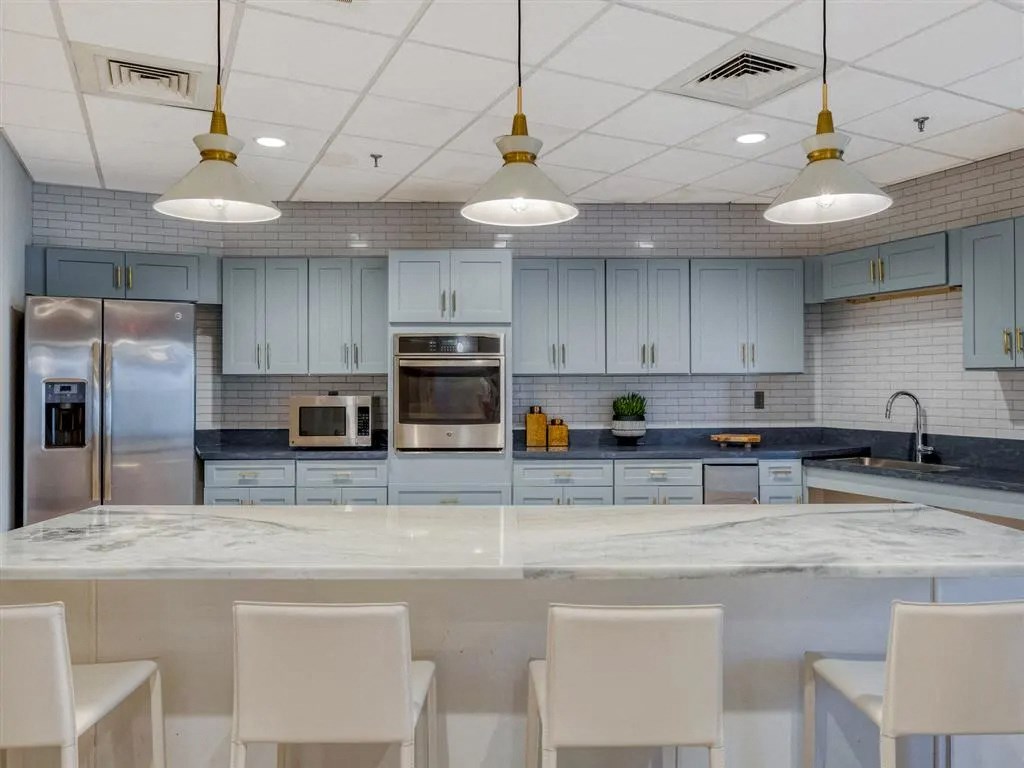a large kitchen with blue cabinets and a counter top