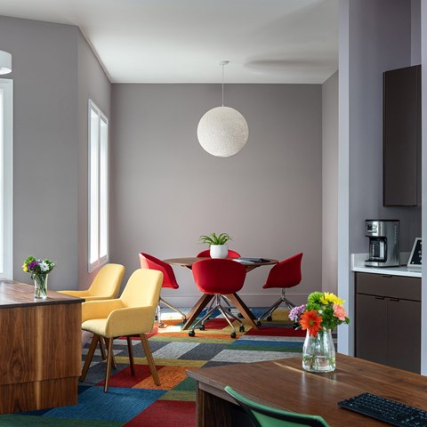 A modern dining room with a wooden table and chairs.