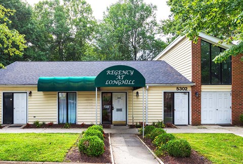 A building with a green awning and a sign that says "REGENCY AREA TOWNSHIP".