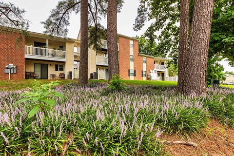 A building with a green lawn in front of it.