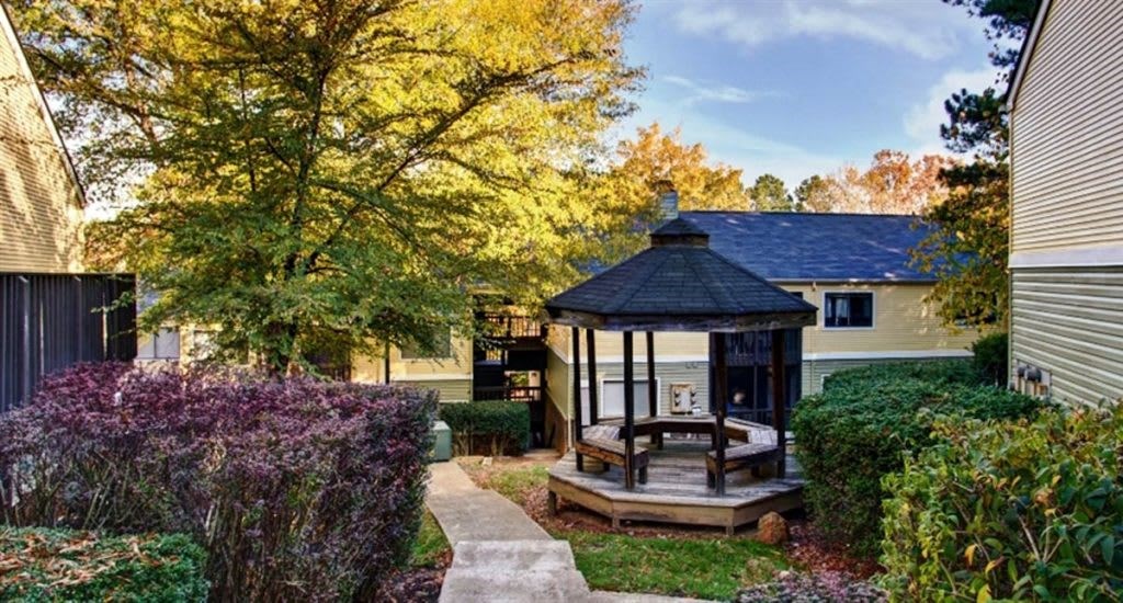 a gazebo in the backyard of a home