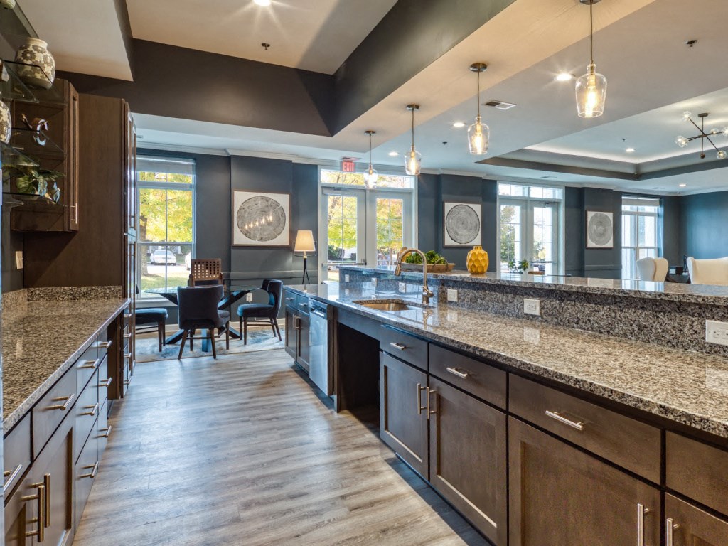 a large kitchen with granite counter tops and a dining area