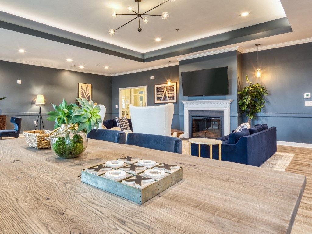 a living room with a wooden table and a fireplace