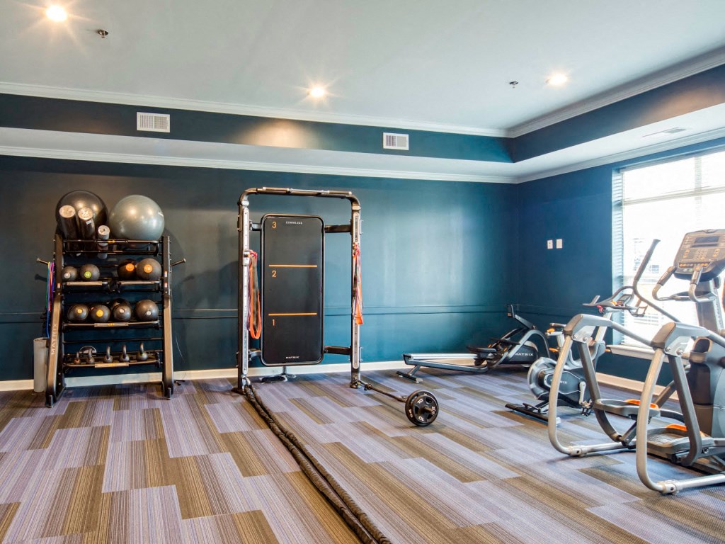 the gym at the district flats apartments in lenexa